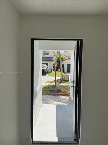 an empty room with windows and painted walls