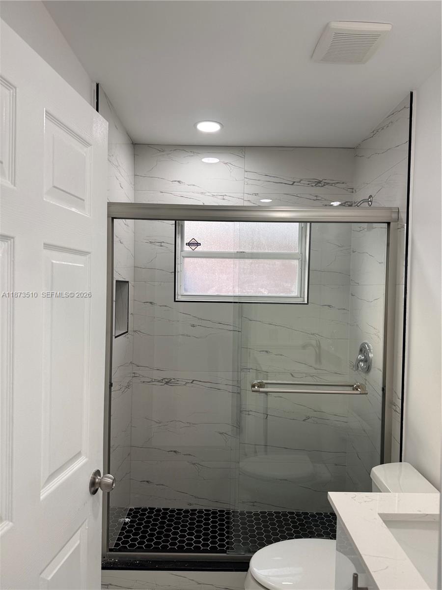 15921 Southwest 82nd Street Miami, FL 33193 - Photo 15 of 20 a bathroom with a toilet and a shower