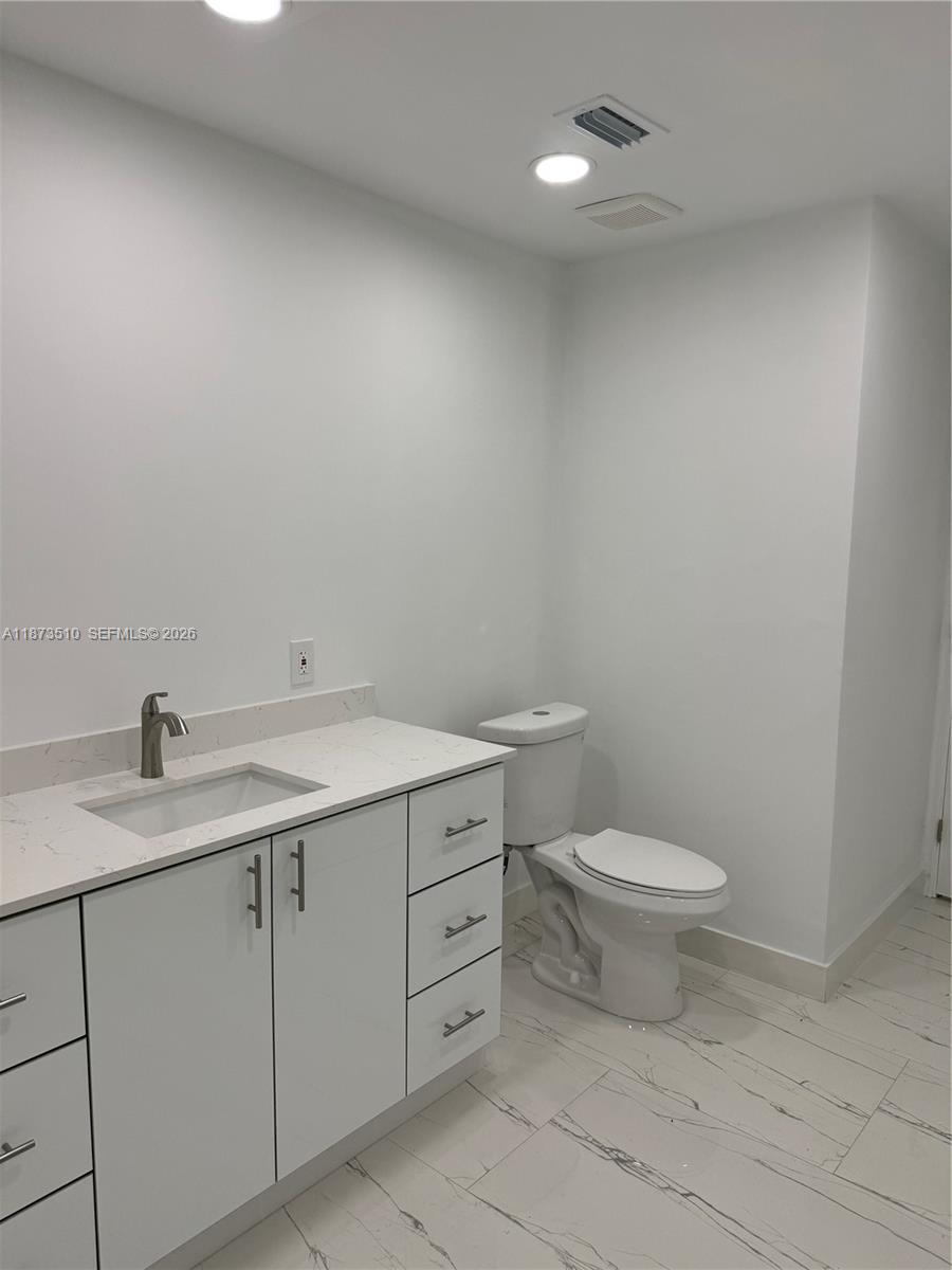 15921 Southwest 82nd Street Miami, FL 33193 - Photo 19 of 20 a bathroom with a toilet sink and mirror