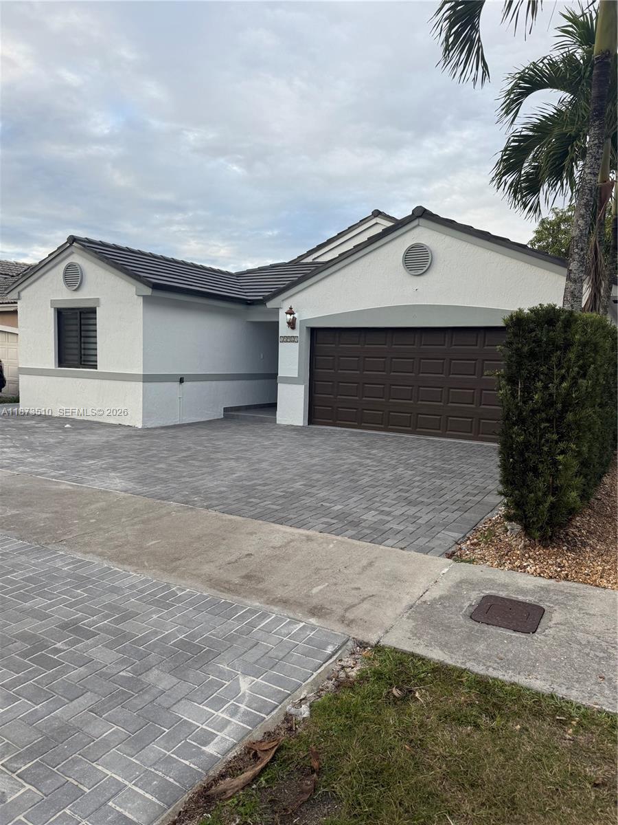 15921 Southwest 82nd Street Miami, FL 33193 - Photo 2 of 20 a house with yard in front of it