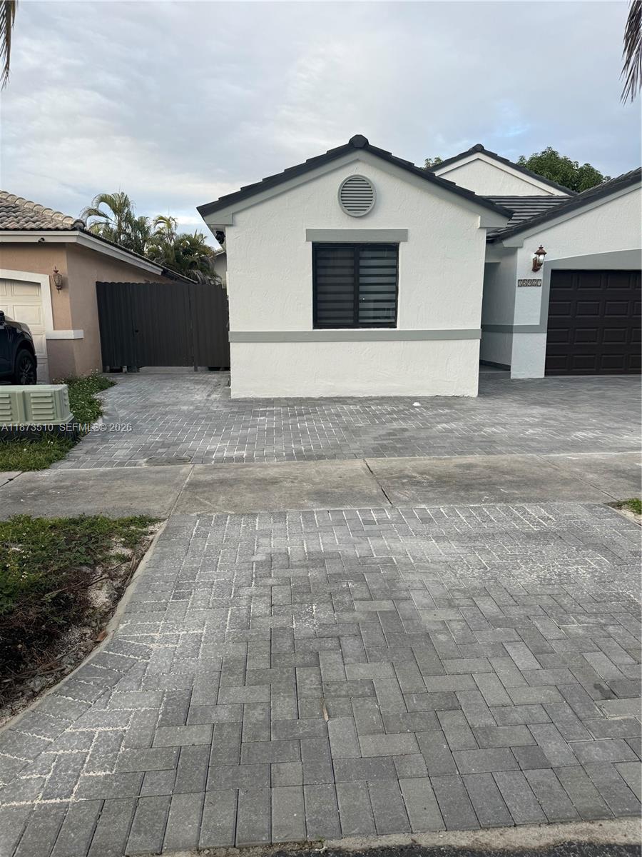 15921 Southwest 82nd Street Miami, FL 33193 - Photo 4 of 20 a front view of a house with a yard and garage