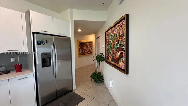 a kitchen with counter top space appliances and living room