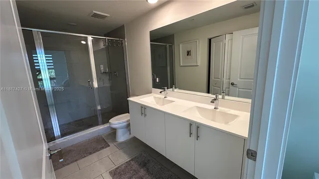 a en suite bathroom with a sink and mirror