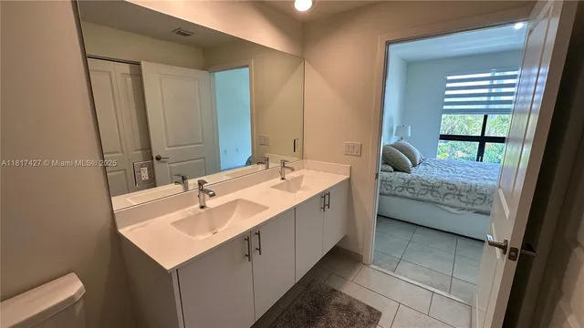 a bedroom with a bed and a mirror