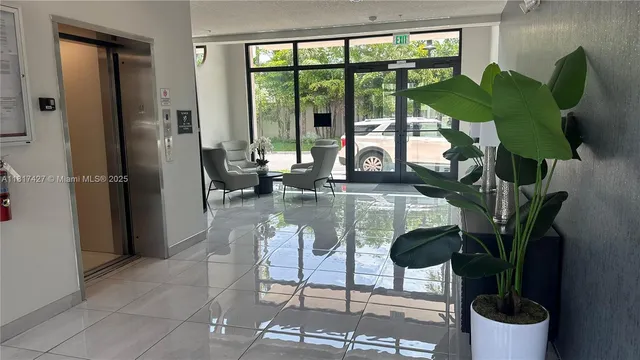 a dining room with furniture and a potted plant