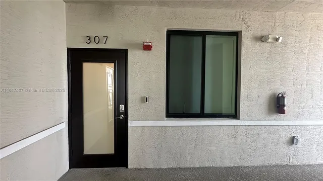 a hallway with a dining table and chairs