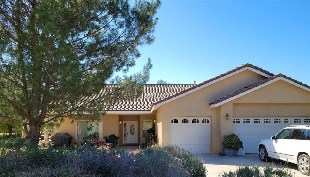 17157 Gamble Avenue Riverside, CA 92504 - Photo 2 of 11 a front view of a house with garden