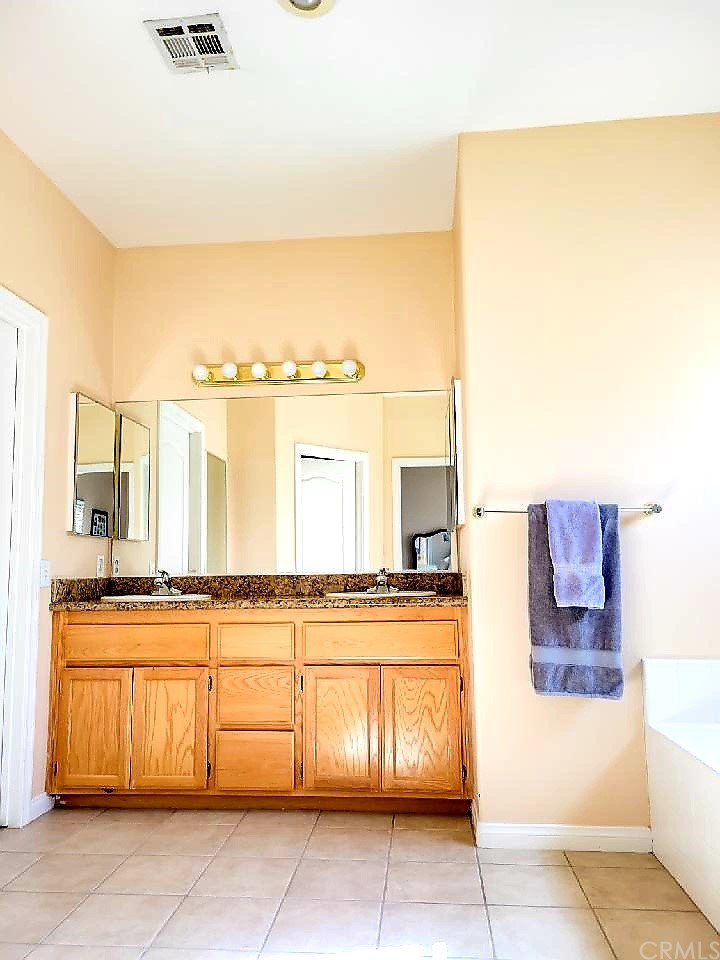 17157 Gamble Avenue Riverside, CA 92504 - Photo 6 of 11 a kitchen with a sink and cabinets