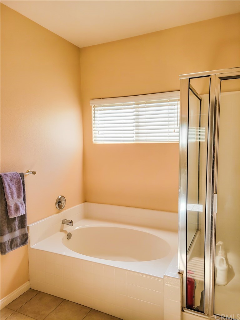 17157 Gamble Avenue Riverside, CA 92504 - Photo 7 of 11 a bathroom with a bathtub and shower