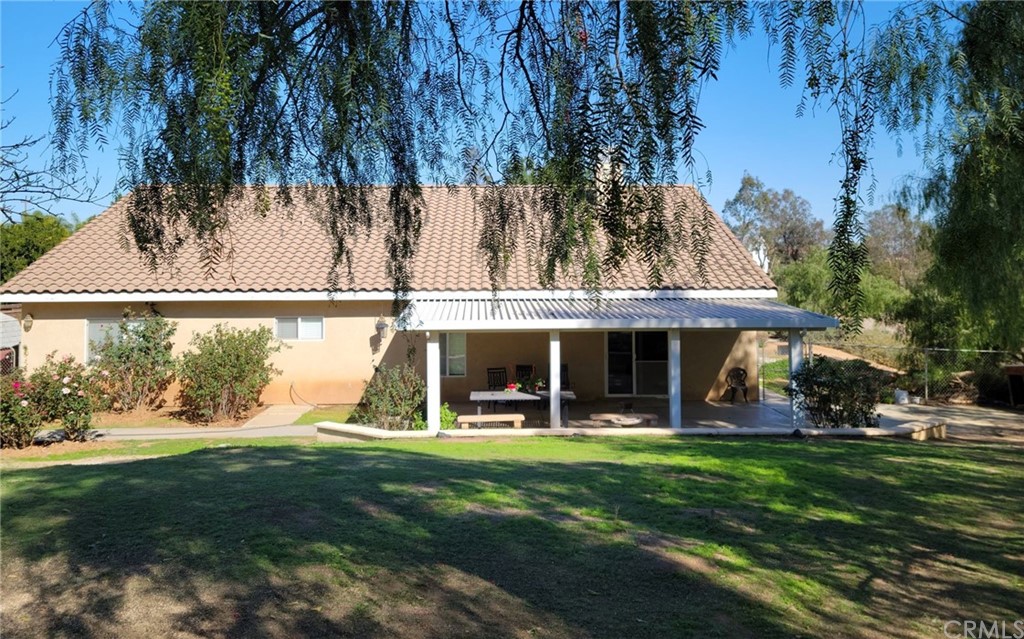 17157 Gamble Avenue Riverside, CA 92504 - Photo 9 of 11 a view of a swimming pool with lawn chairs and a big yard