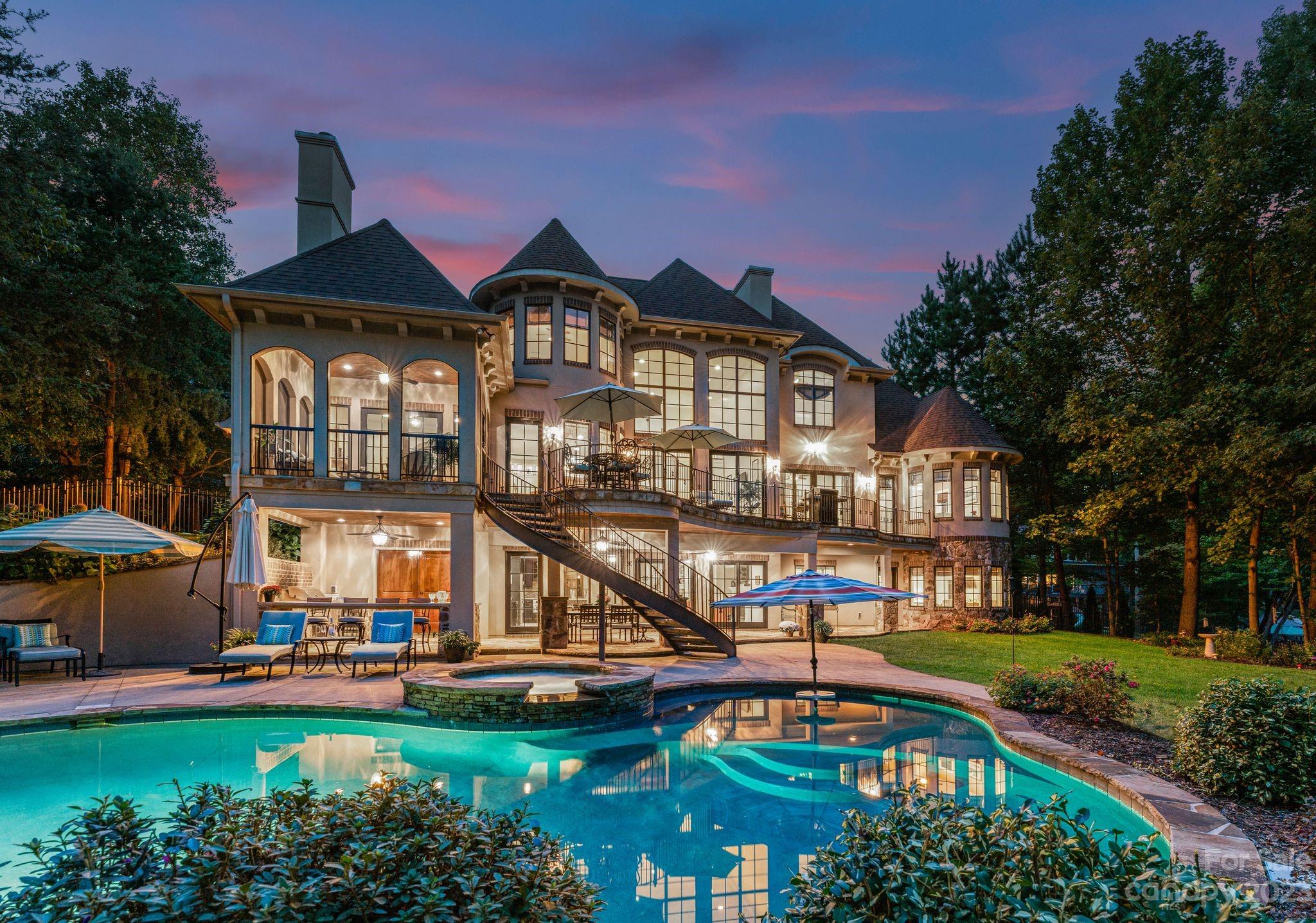 a front view of a house with swimming pool having outdoor seating