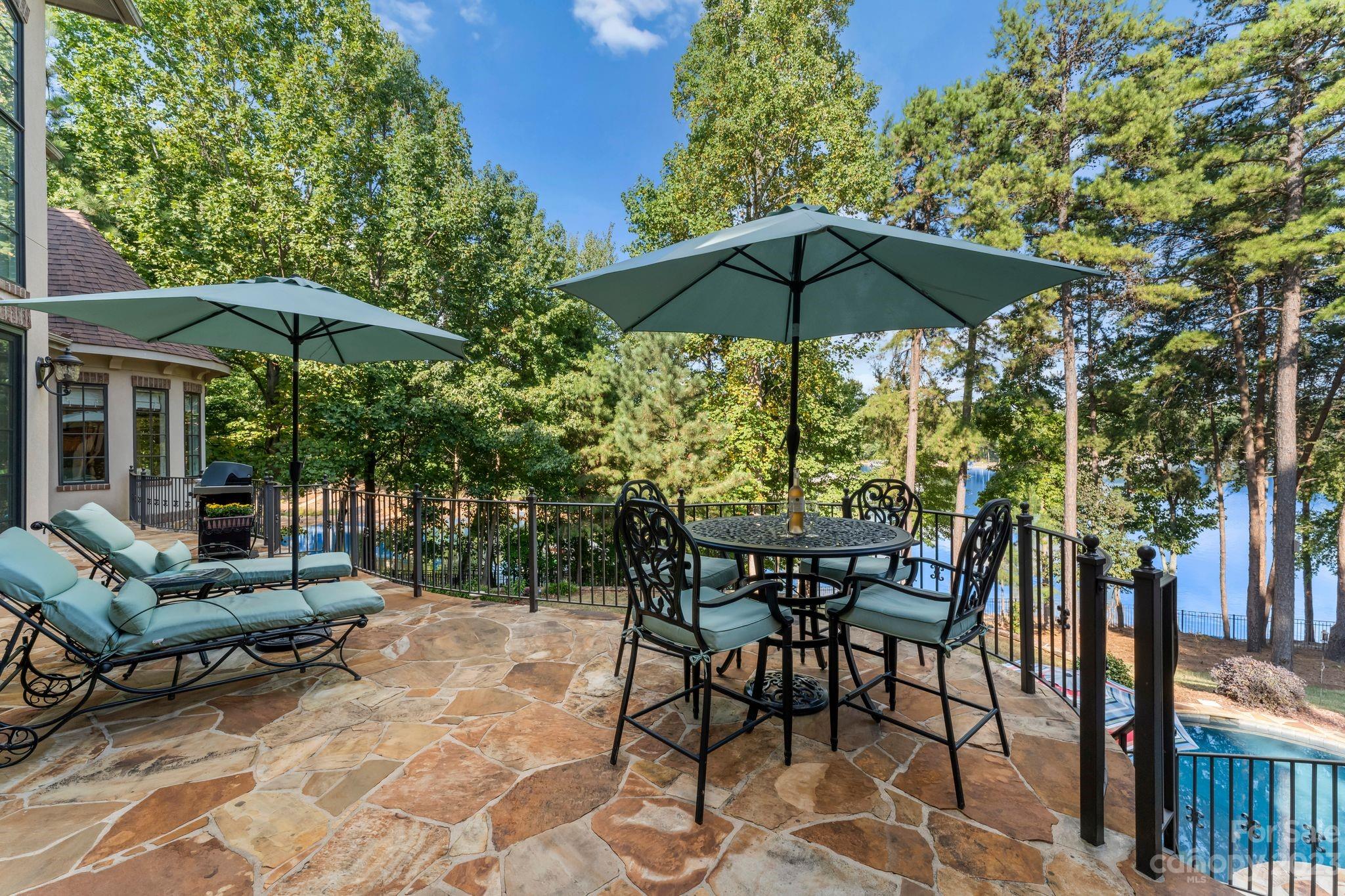 413 Bay Harbour Road Mooresville, NC 28117 - Photo 37 of 47 a view of patio with chairs and table under an umbrella