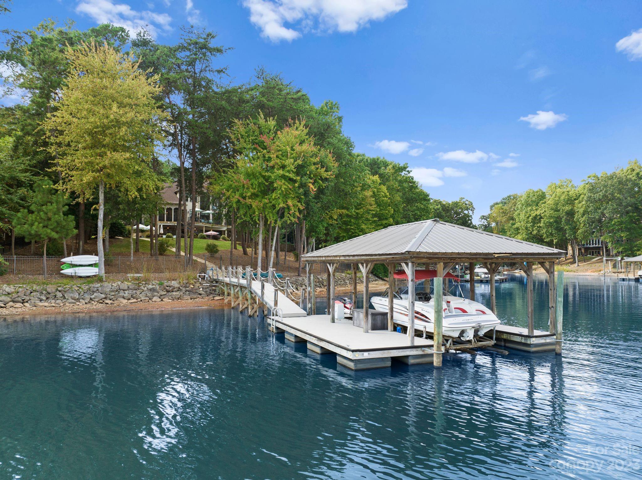 413 Bay Harbour Road Mooresville, NC 28117 - Photo 38 of 47 a view of a lake with lawn chairs under an umbrella