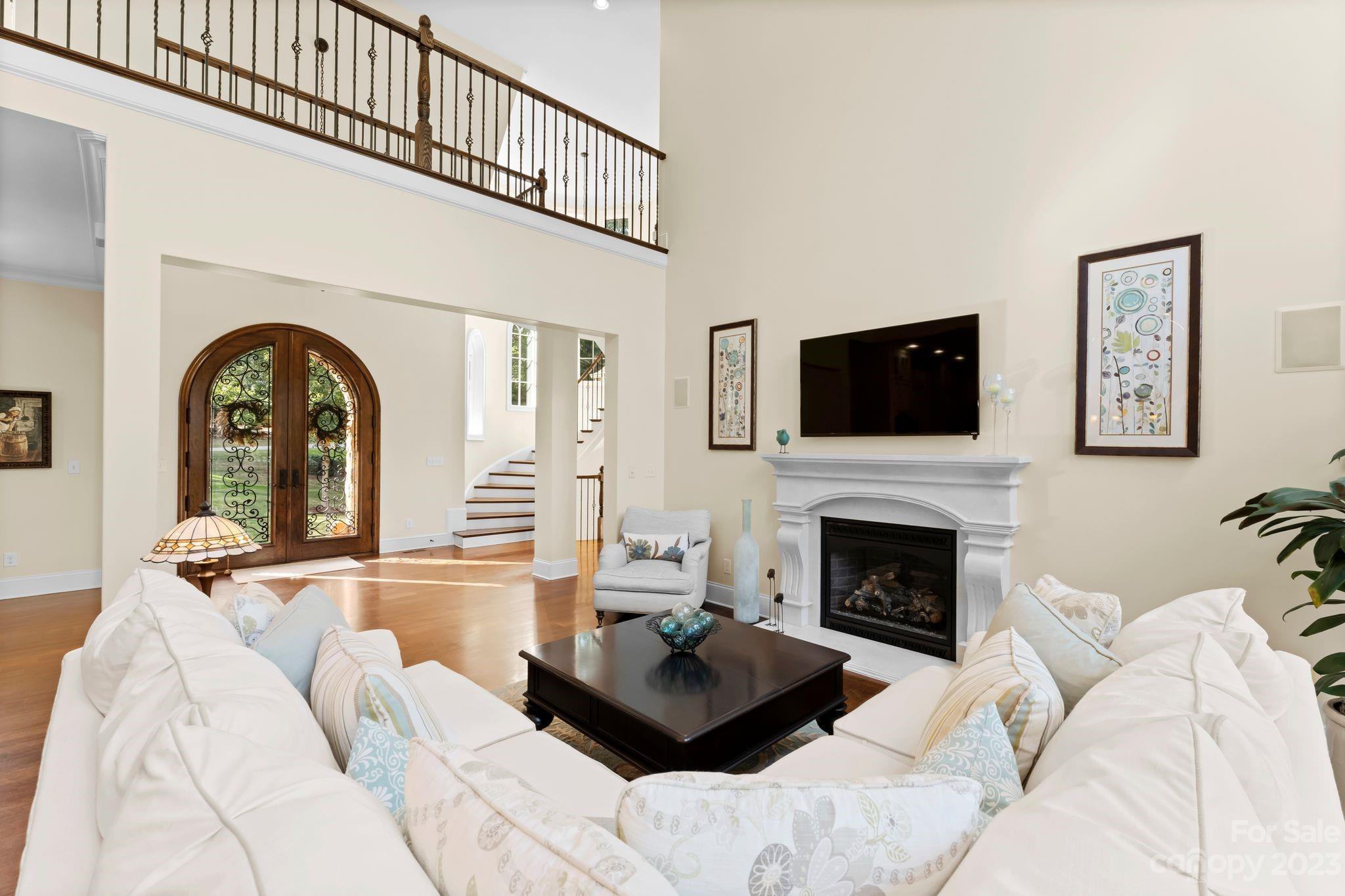 413 Bay Harbour Road Mooresville, NC 28117 - Photo 6 of 47 a living room with furniture a fireplace and a flat screen tv