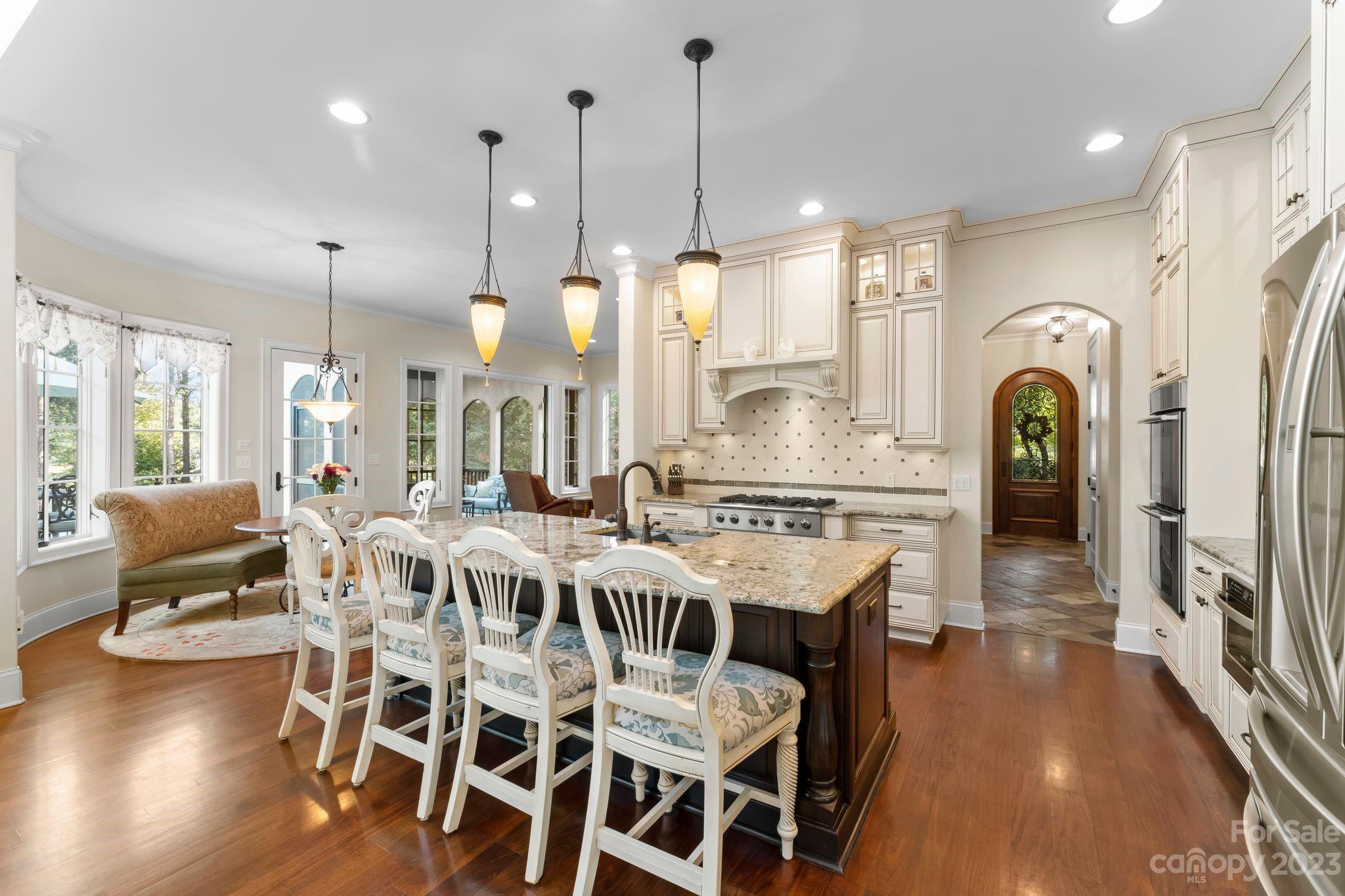 413 Bay Harbour Road Mooresville, NC 28117 - Photo 7 of 47 a large kitchen with a table and chairs
