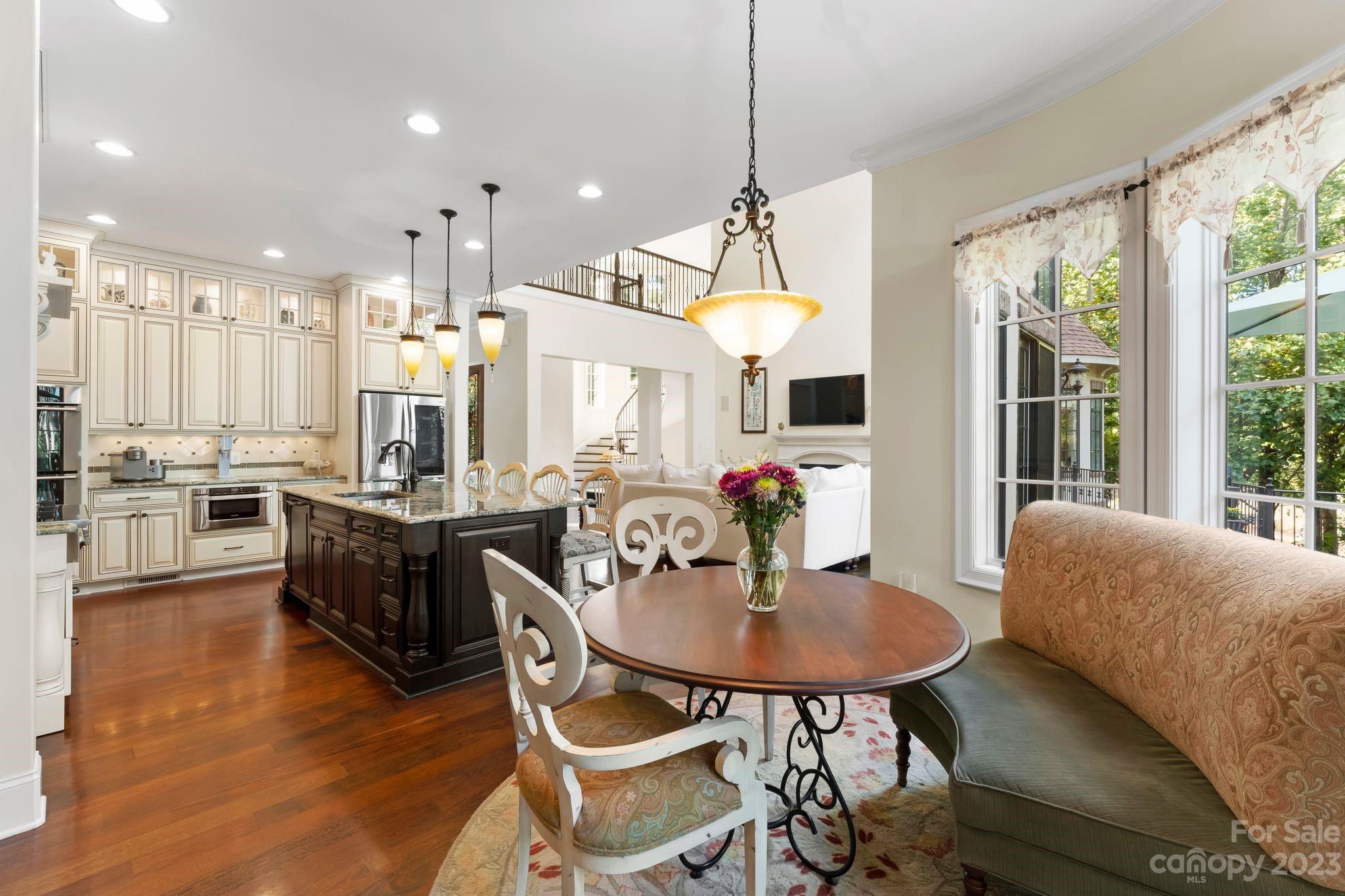 413 Bay Harbour Road Mooresville, NC 28117 - Photo 10 of 47 a view of a dining room and livingroom with furniture wooden floor a chandelier