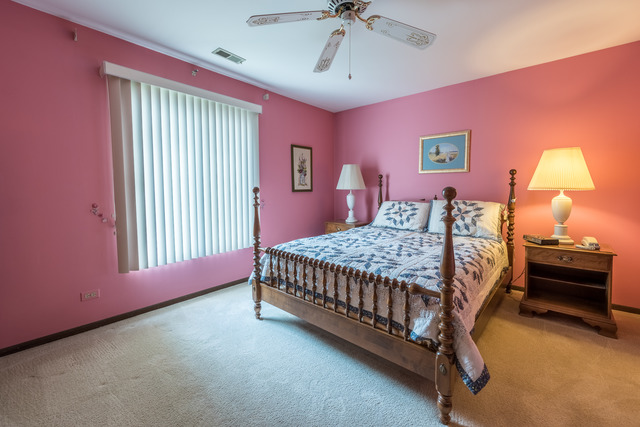 1471 Haverhill Drive, Unit B Wheaton, IL 60189 - Photo 15 of 25 a bedroom with a bed and a chandelier