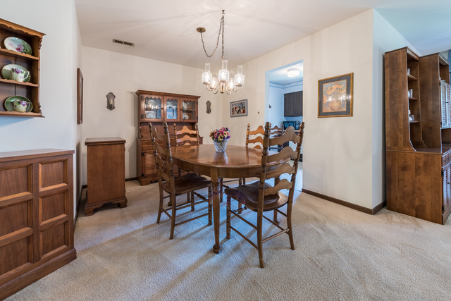 1471 Haverhill Drive, Unit B Wheaton, IL 60189 - Photo 8 of 25 a view of a dining room with furniture and chandelier