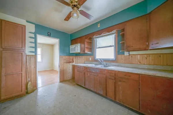 a kitchen with granite countertop a sink and cabinets