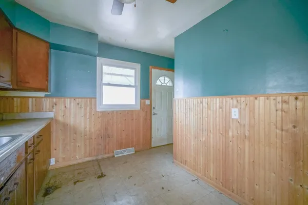 a view of a kitchen with wooden cabinets