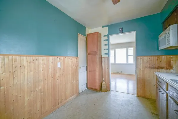 a view of a kitchen with refrigerator and cabinet