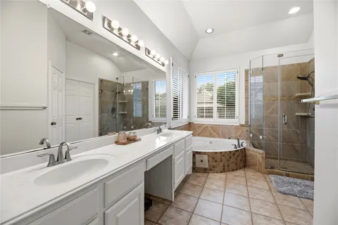 a bathroom with a tub sink and mirror