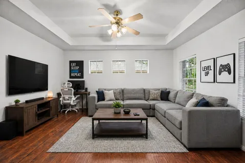 a living room with furniture and a flat screen tv