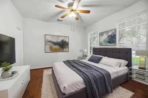 a bedroom with a bed and a flat screen tv