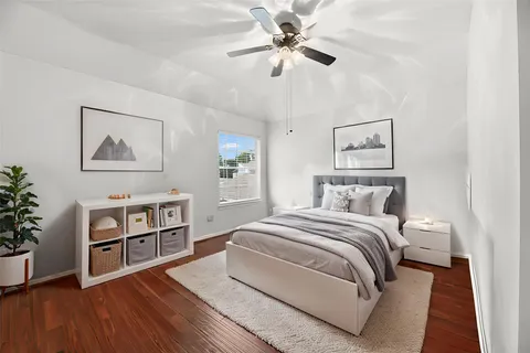 a bedroom with a bed chandelier and a window