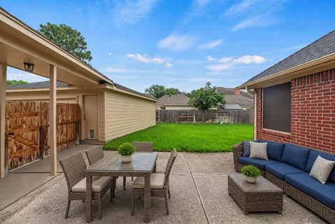 a view of a patio with couches under an umbrella
