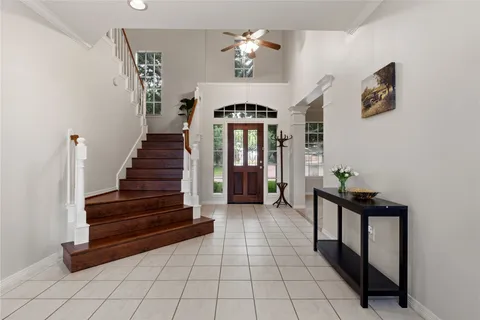 a view of entryway with stairs and a chandelier