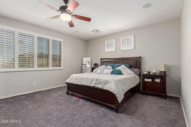 a bedroom with bed and a large window