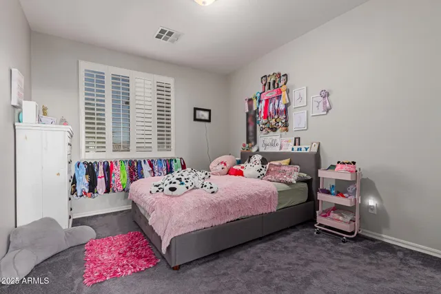 a bedroom with a bed dresser and a window