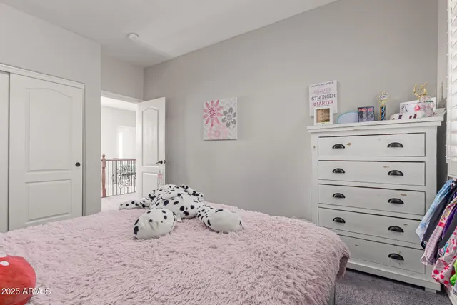 a bedroom with a bed and a dresser