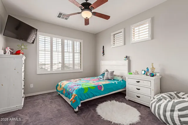 a bedroom with a bed and a tv