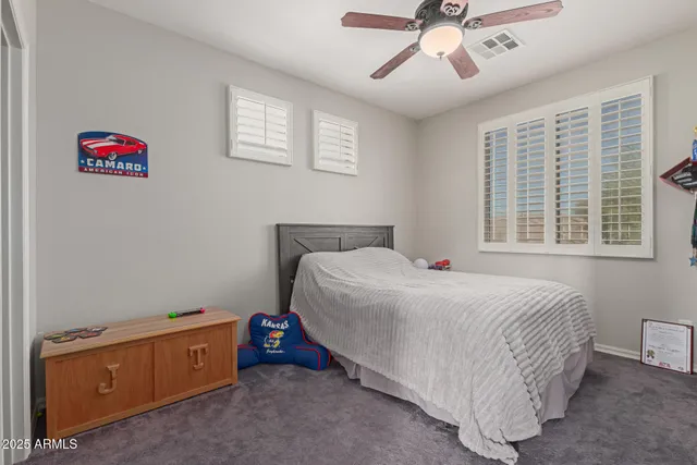 a bedroom with a bed and a dresser