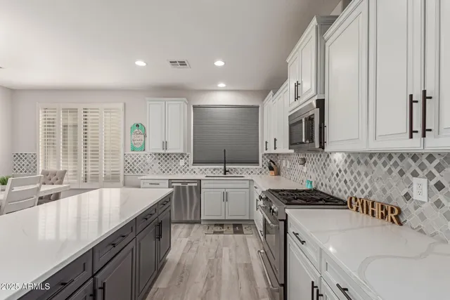 a kitchen with a sink stove and cabinets