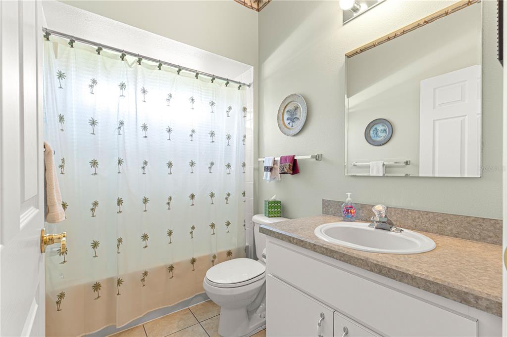5543 Northwest 25th Loop Ocala, FL 34482 - Photo 2 of 50 a bathroom with a granite countertop sink toilet and a shower