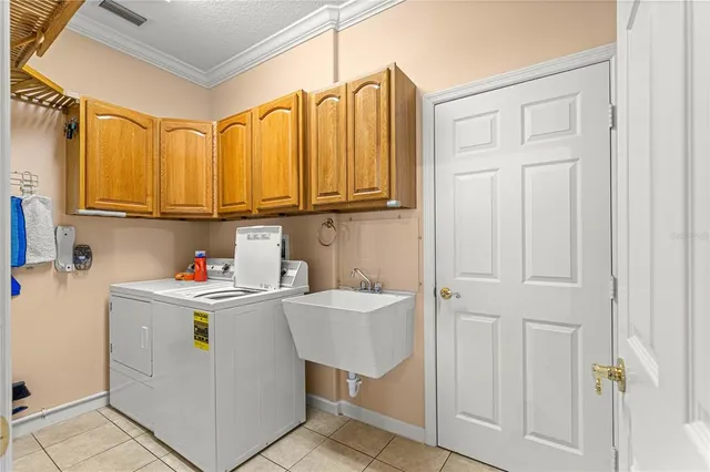 a utility room with stainless steel appliances granite countertop a washer and dryer