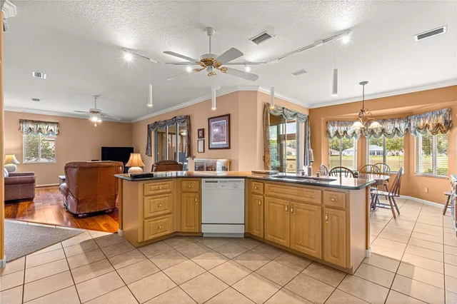 a kitchen with sink cabinets and dining table