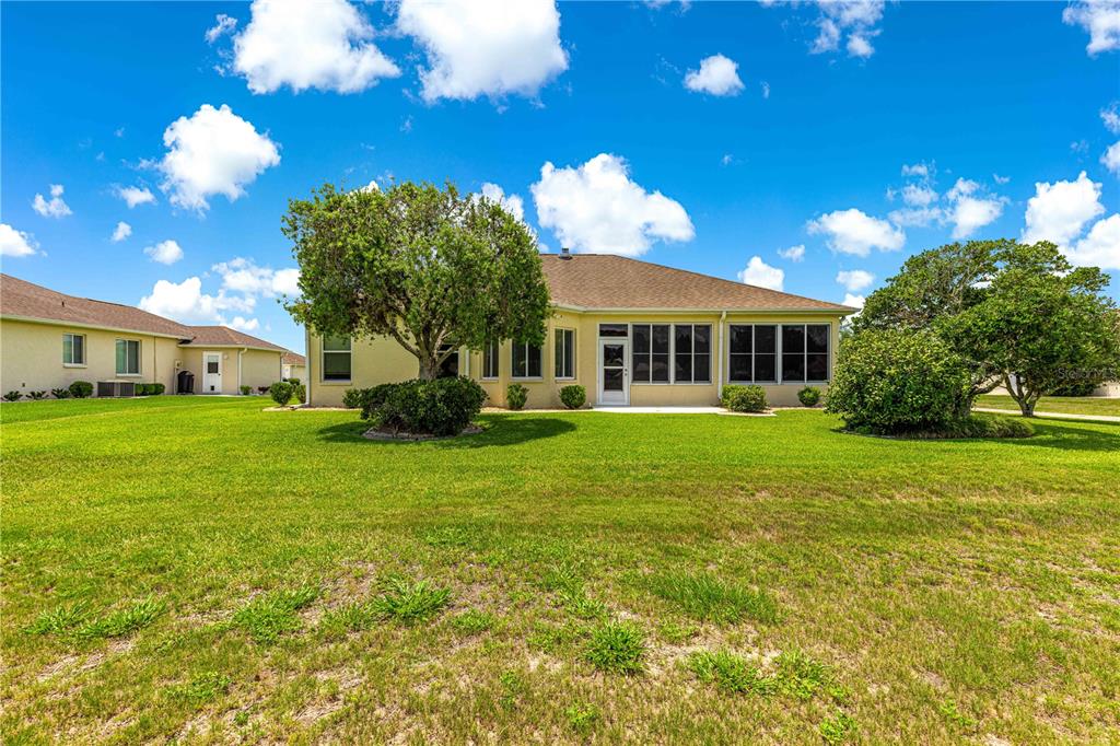 5543 Northwest 25th Loop Ocala, FL 34482 - Photo 44 of 50 a view of a house with a big yard and potted plants