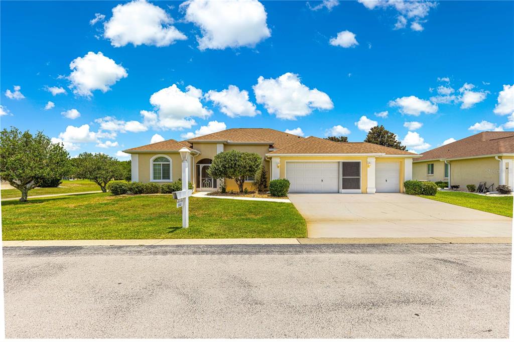 5543 Northwest 25th Loop Ocala, FL 34482 - Photo 48 of 50 a front view of a house with a yard and garage