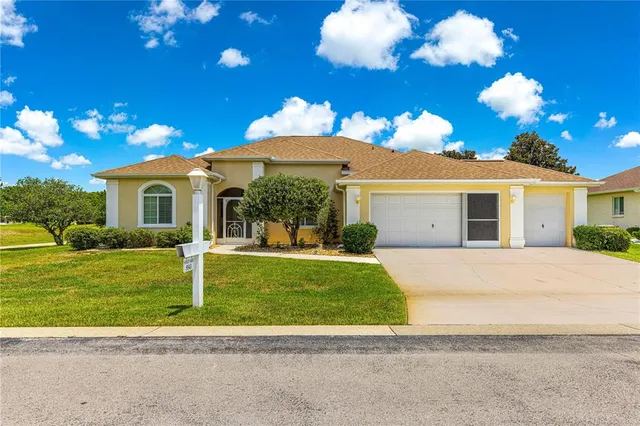 a view of a house with backyard and sitting area