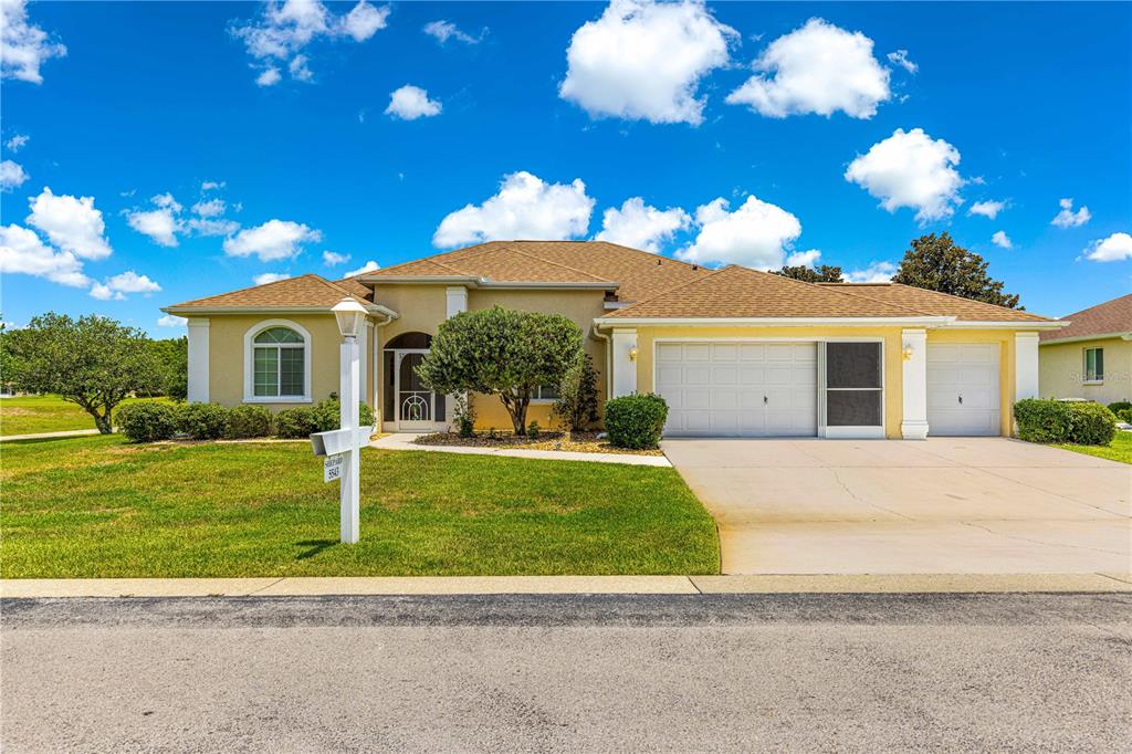 5543 Northwest 25th Loop Ocala, FL 34482 - Photo 49 of 50 a front view of a house with a garden