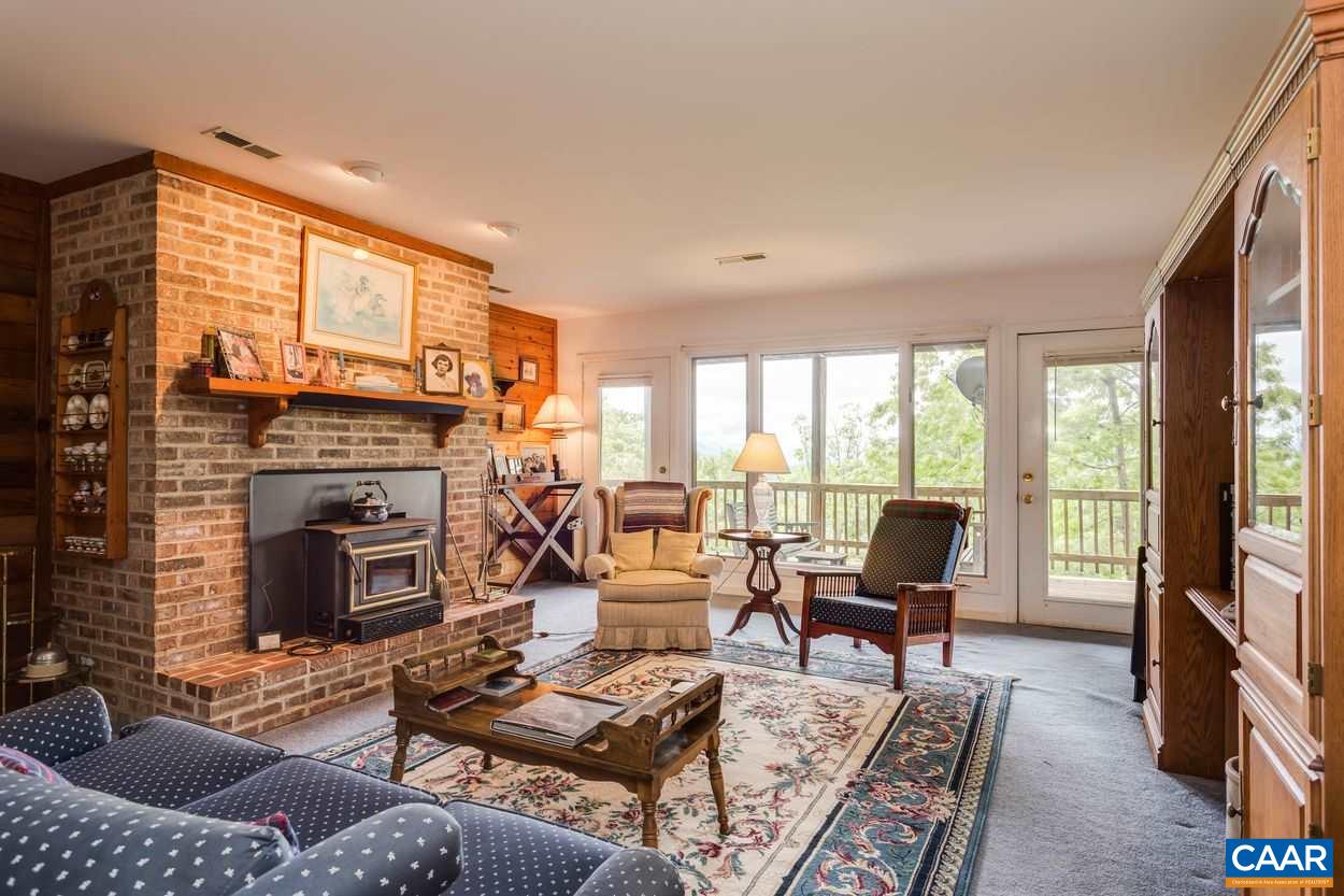 148 Old Stony Ridge Road Afton, VA 22920 - Photo 26 of 32 a living room with furniture fireplace and a large window