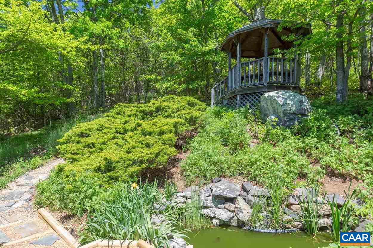148 Old Stony Ridge Road Afton, VA 22920 - Photo 3 of 32 a backyard of a house with lots of green space and fountain