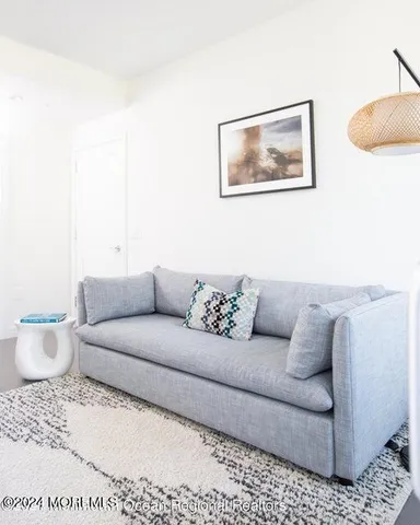 a living room with furniture and a rug
