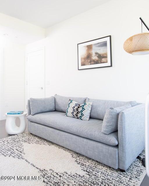 30 Melrose Terrace, Unit 201 Long Branch, NJ 07740 - Photo 13 of 33 a living room with furniture and a rug