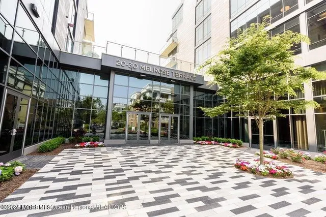 a backyard of a building with barbeque oven table and chairs