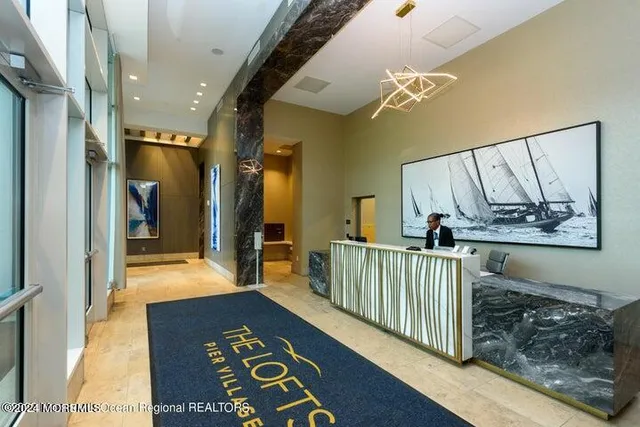 a view of hallway with furniture and windows